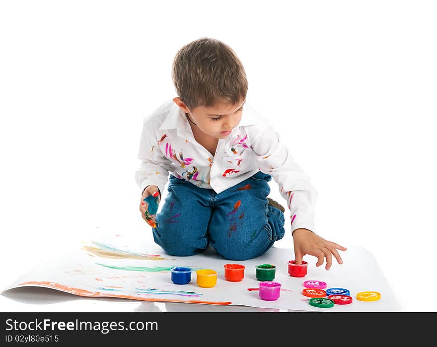 Cute little boy covered in bright paint