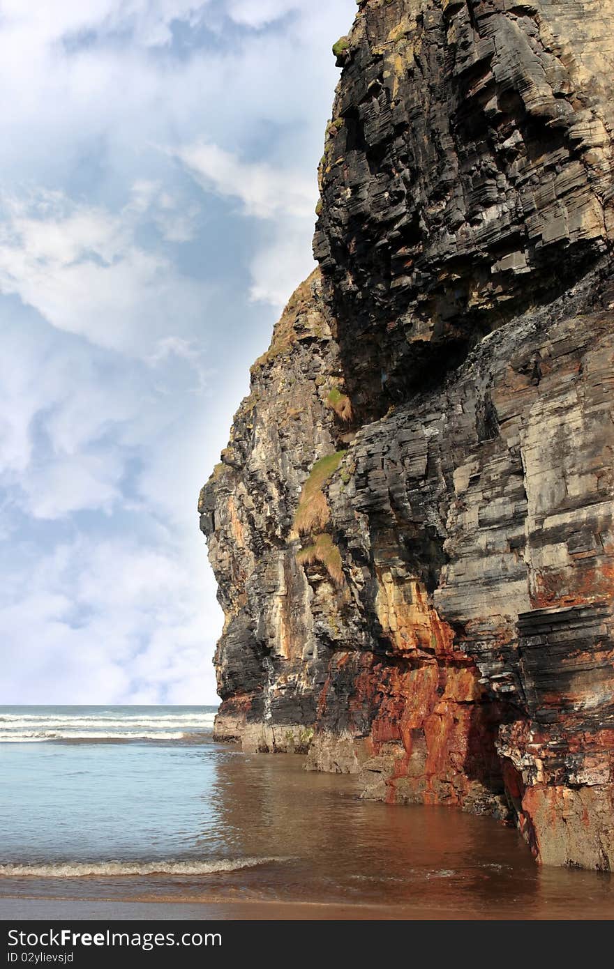 Cliff reflected on ballybunion beach