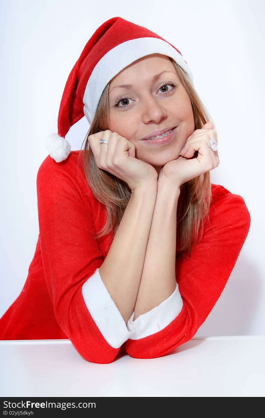 Beautiful young smiling girl in Santa red hat