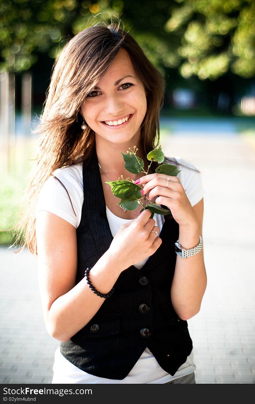 Young smiling girl with linden blossom. Young smiling girl with linden blossom