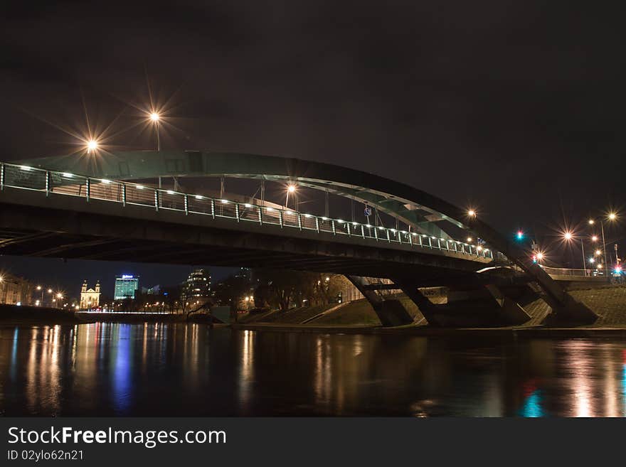 Modern bridge in the Vilnius city center over Neris river, photographed at night. Modern bridge in the Vilnius city center over Neris river, photographed at night