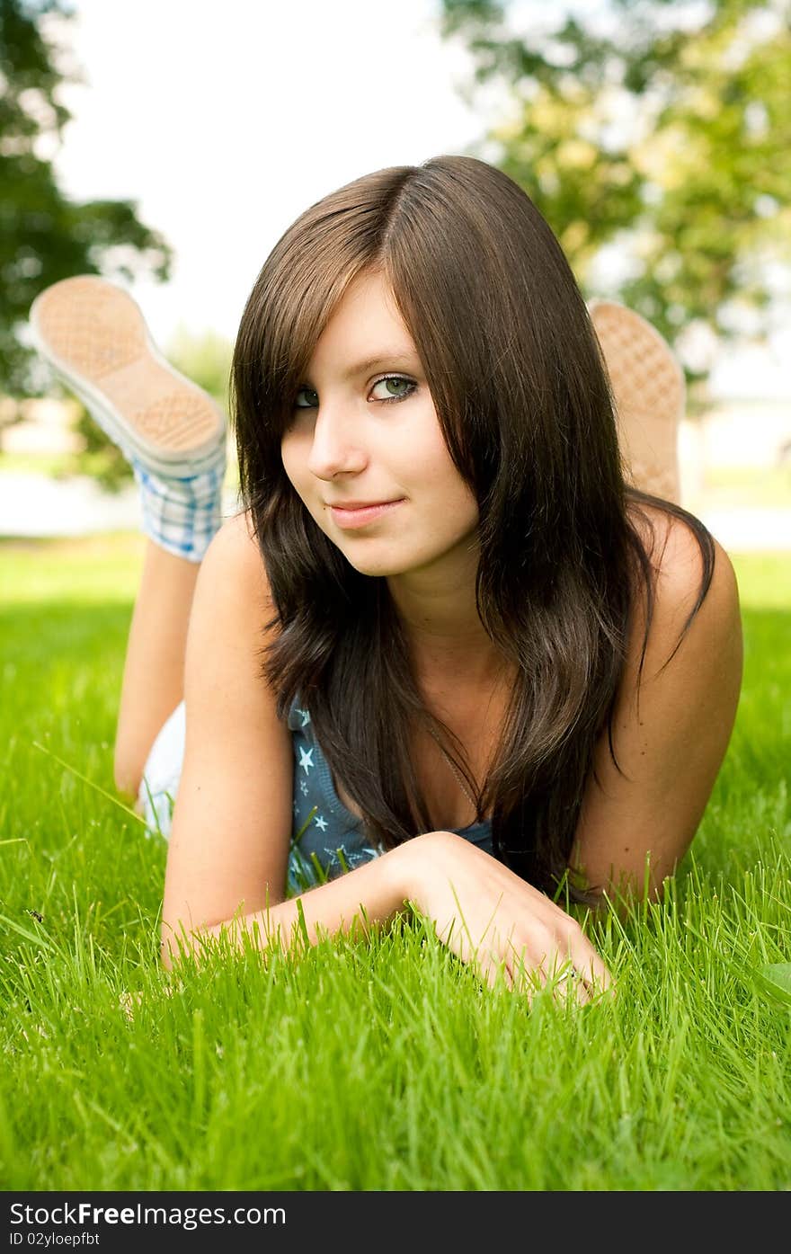 Young girl lying in grass