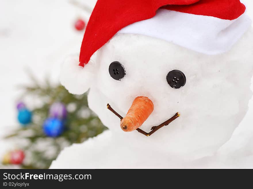 Close-up snowman on christmas tree background. Close-up snowman on christmas tree background