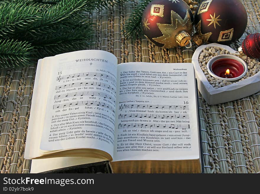 Whipped hymnal in front of a candle. Whipped hymnal in front of a candle