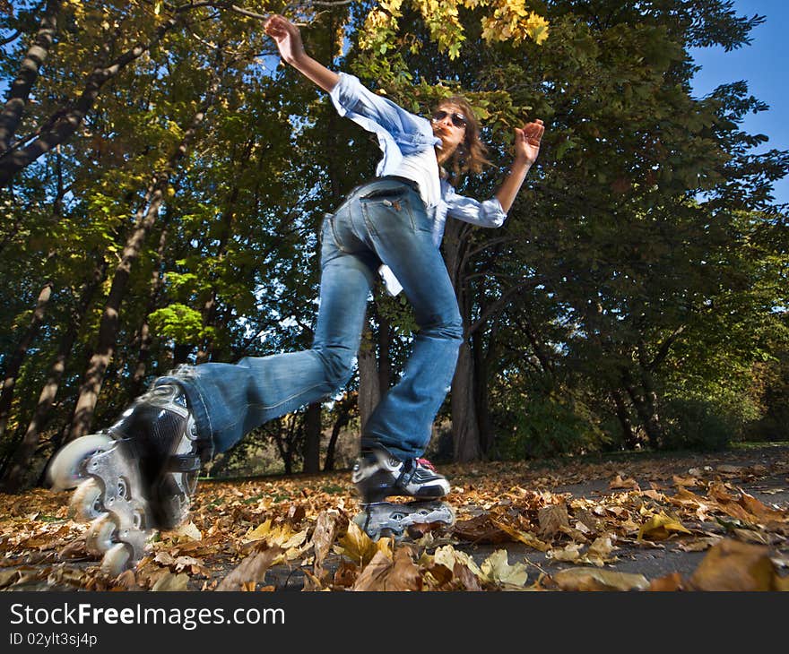 Wide-angle shot of a running rollerskater - strong motion blur on person. Wide-angle shot of a running rollerskater - strong motion blur on person