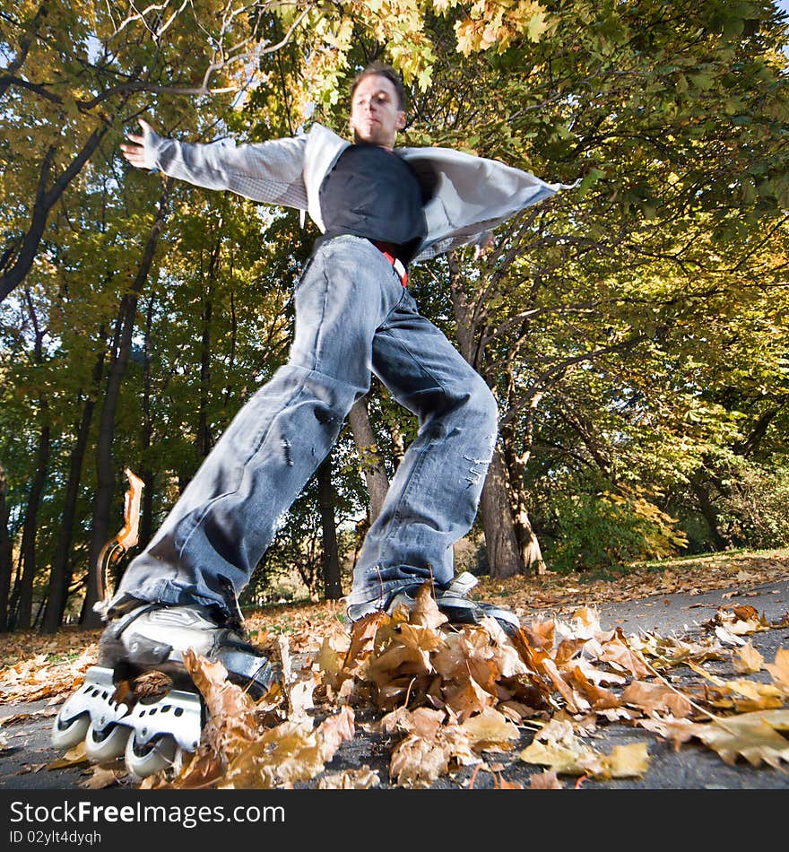 Wide-angle shot of a sliding rollerskater - strong motion blur on person. Wide-angle shot of a sliding rollerskater - strong motion blur on person