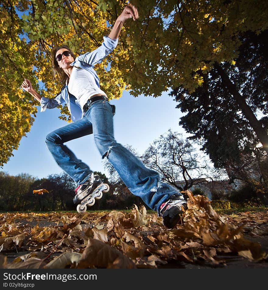 Wide-angle shot of a sliding rollerskater - motion blur on person. Wide-angle shot of a sliding rollerskater - motion blur on person