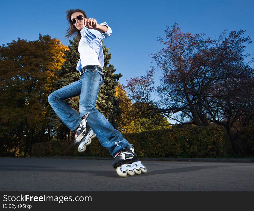 Wide-angle shot of a sliding rollerskater - motion blur on person. Wide-angle shot of a sliding rollerskater - motion blur on person