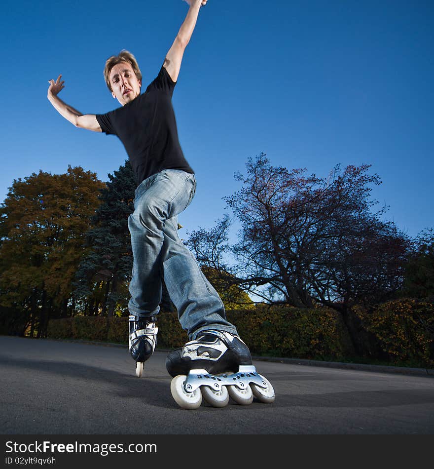 Wide-angle shot of a sliding rollerskater - motion blur on person. Wide-angle shot of a sliding rollerskater - motion blur on person