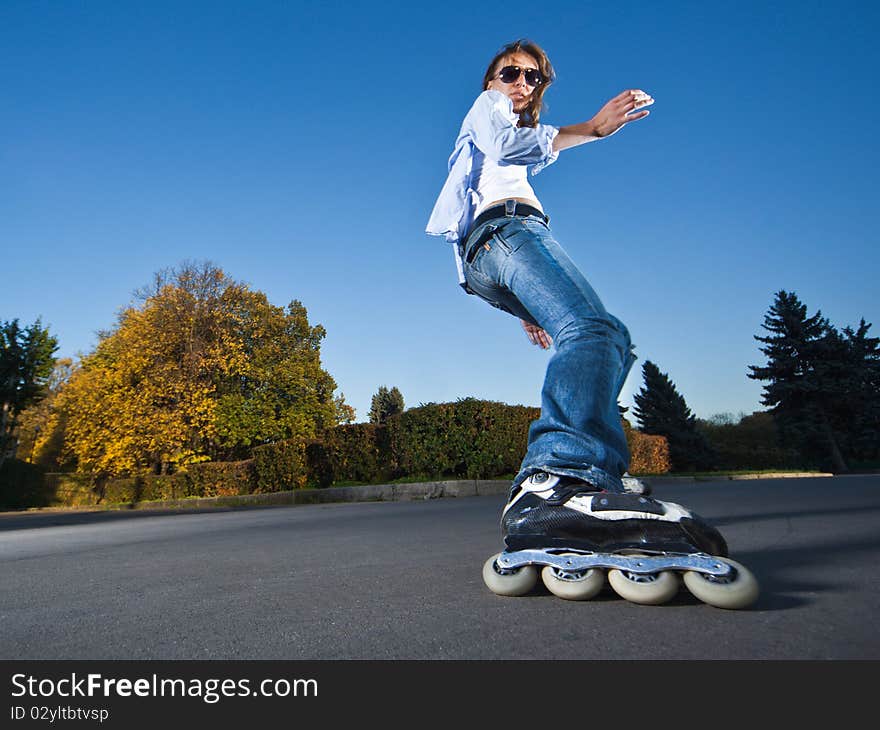 Wide-angle shot of a sliding rollerskater - motion blur on person. Wide-angle shot of a sliding rollerskater - motion blur on person