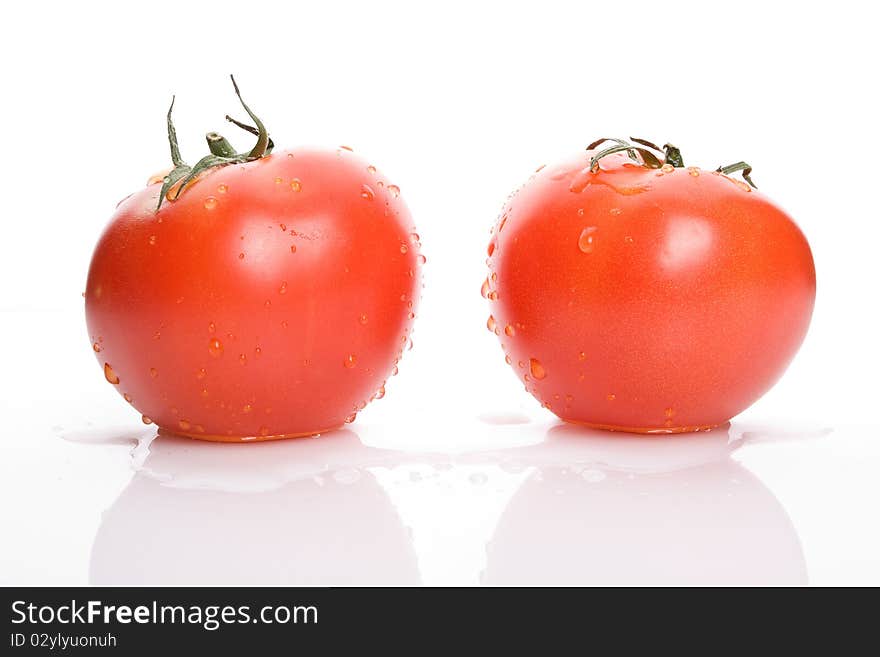 Two red tomatoes with water drops