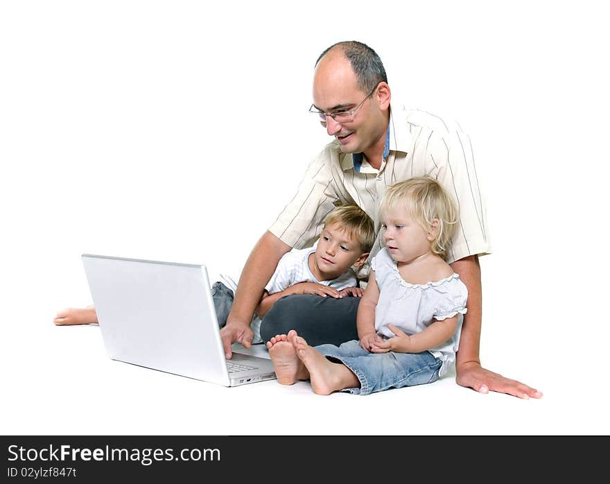 Studio shot of father and two kids with laptop over white