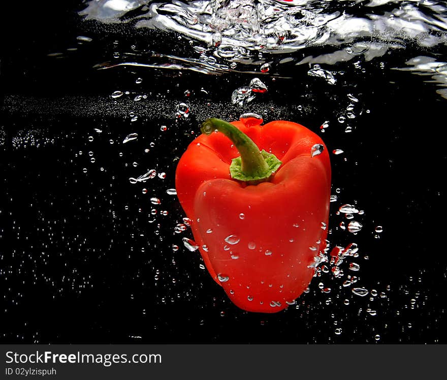 Red pepper splashing in water