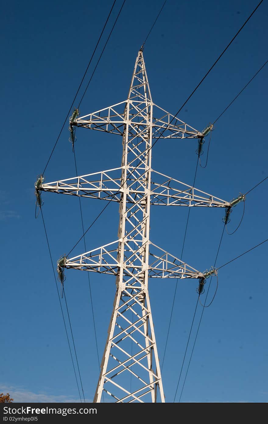 High voltage pylon against blue sky. High voltage pylon against blue sky