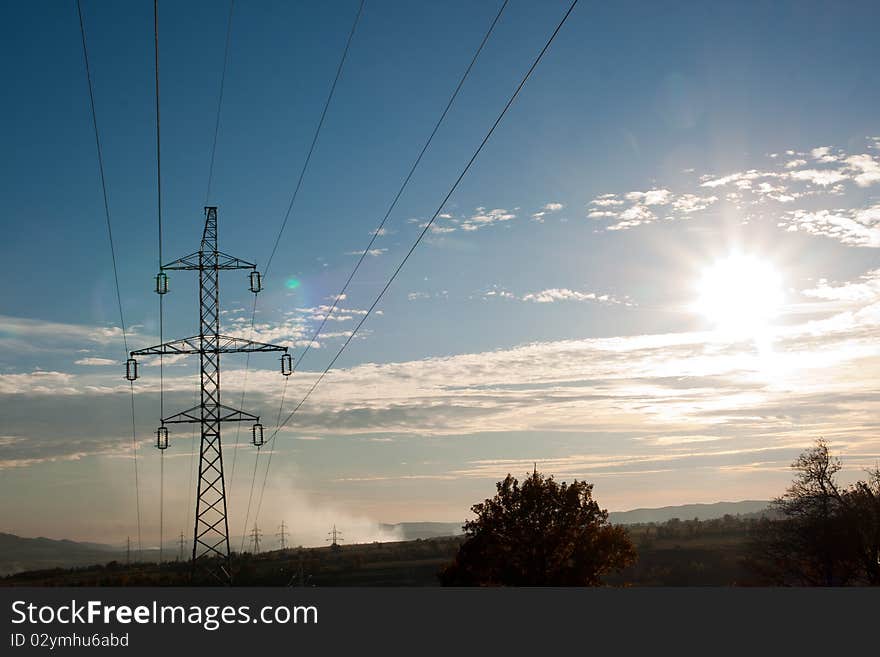 High voltage pylon against blue sky. High voltage pylon against blue sky