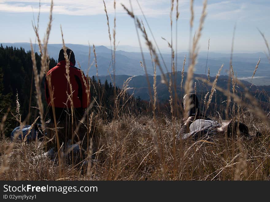 Tourists on mountain top looking. Tourists on mountain top looking