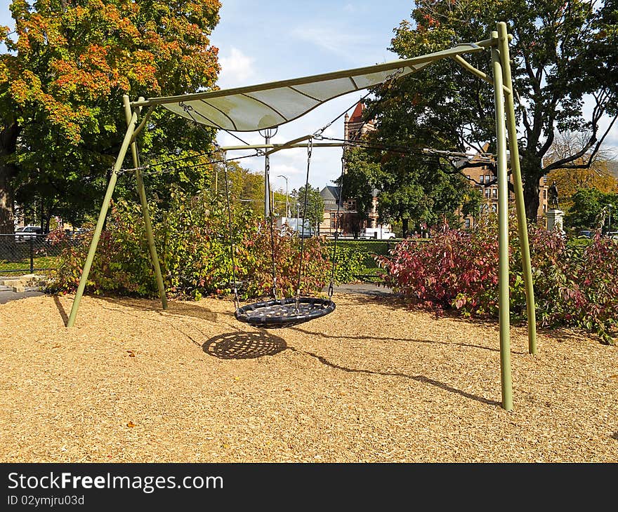 Swing set in childrens playground on a sunny fall day. Swing set in childrens playground on a sunny fall day