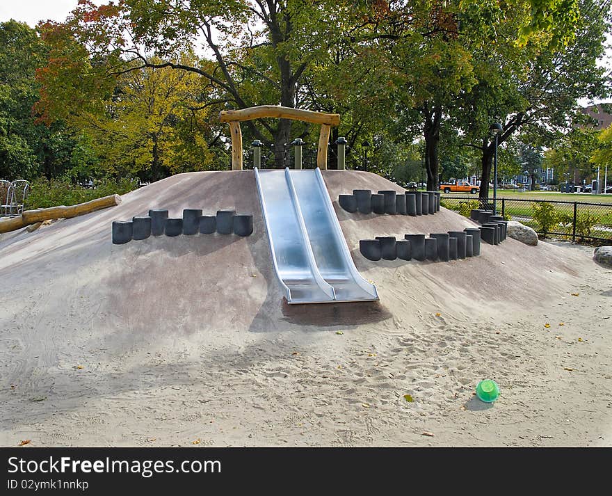 Metal slide in play area in public park. Metal slide in play area in public park