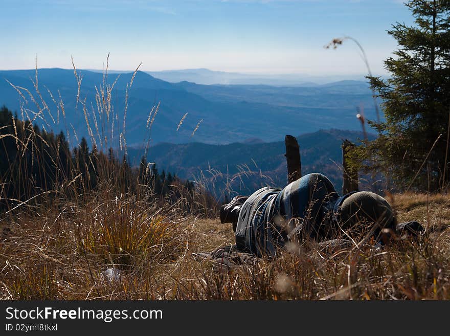 Tourists taking a nap on top of a mountain