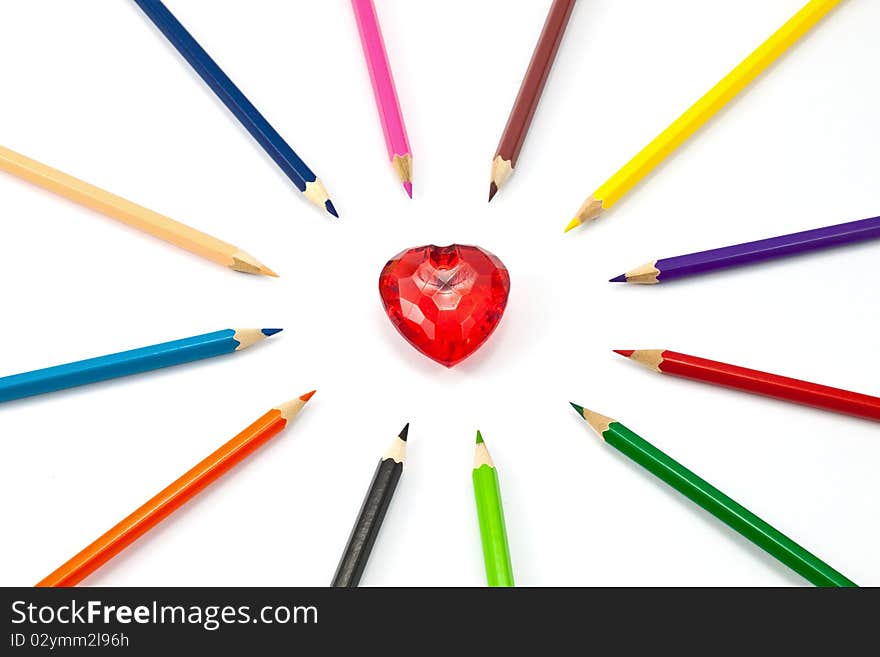 Red crystal heart surrounded with color pencil. Red crystal heart surrounded with color pencil