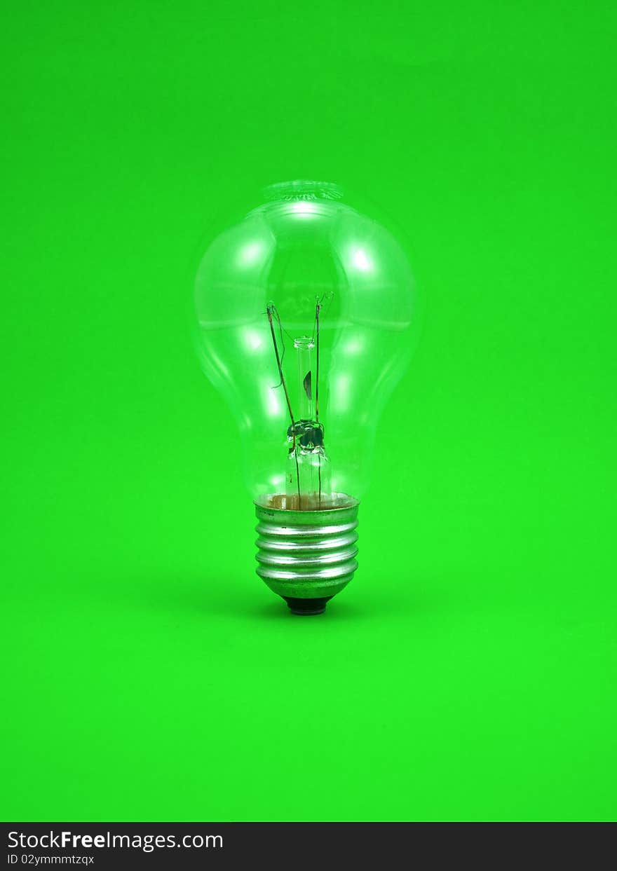 Compact light bulb isolated on green background. Compact light bulb isolated on green background