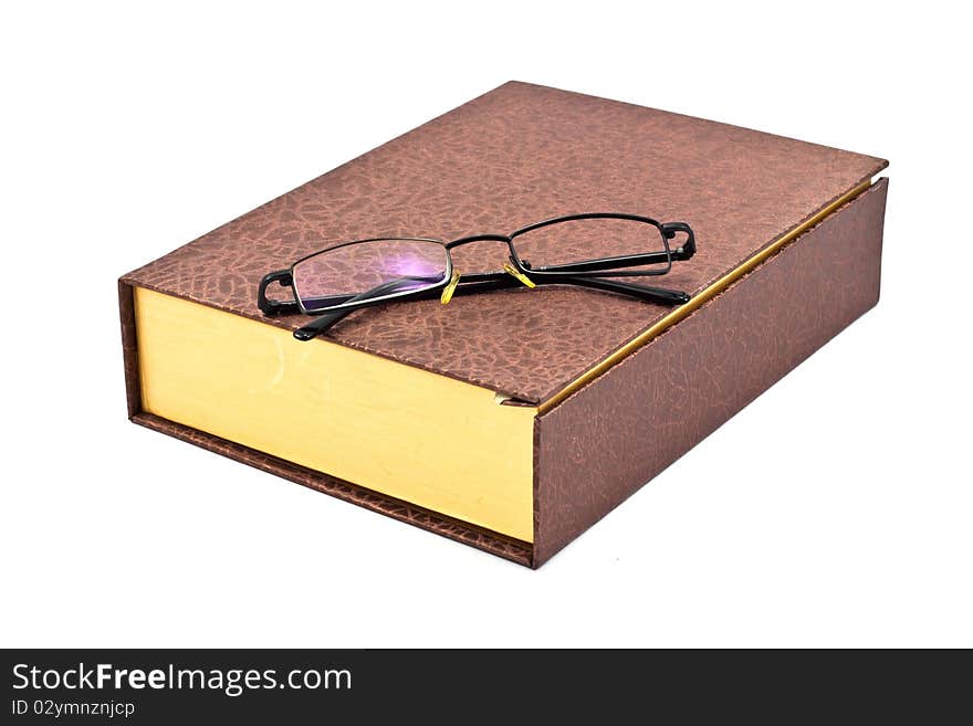 Old brown book and single len eyeglass isolated on a white background. Old brown book and single len eyeglass isolated on a white background