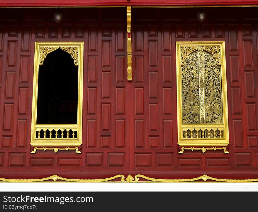 Gold window on wood wall in temple traditional Thai style architecture