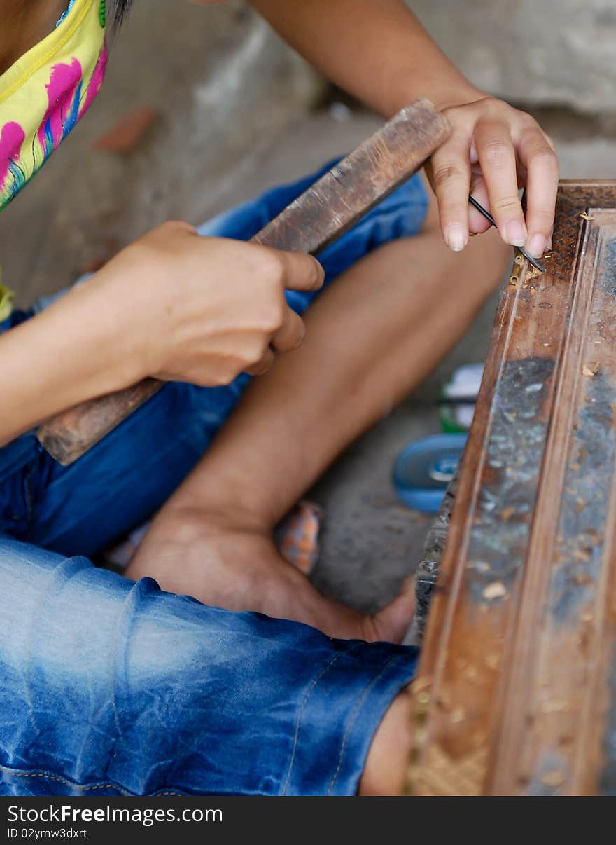 Craftsman is carving wood to create figures with details on the carpentry village in Vietnam. Craftsman is carving wood to create figures with details on the carpentry village in Vietnam.