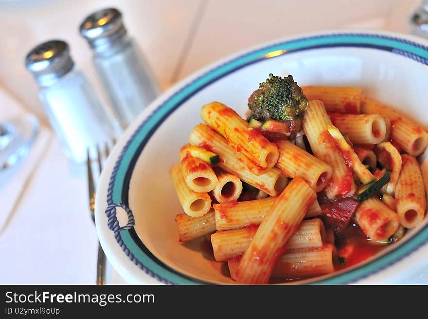 Fusion style tomato pasta cooked with Oriental mixed vegetables.