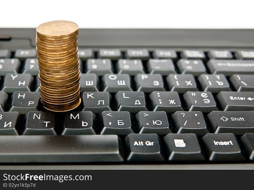 One heap of yellow coins on black keyboard. One heap of yellow coins on black keyboard