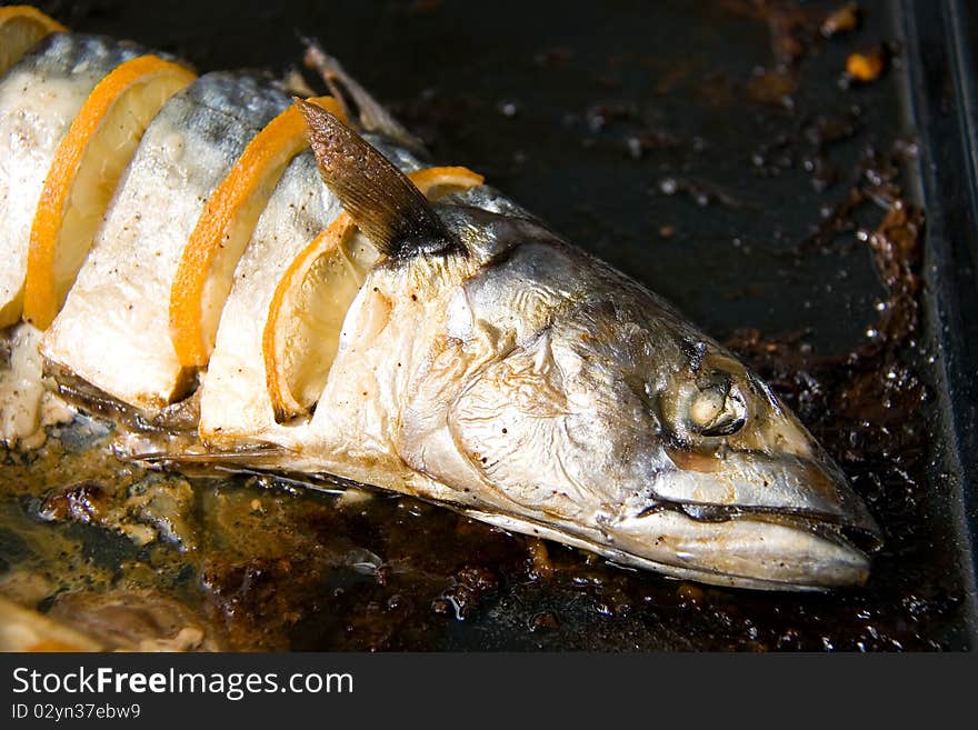 Grilled fish mackerel with lemon on baked dish