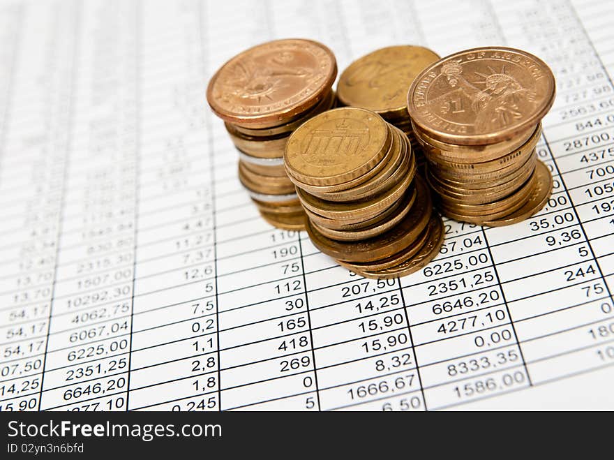 Selective focus shot of money heap on page with financial numbers. Selective focus shot of money heap on page with financial numbers