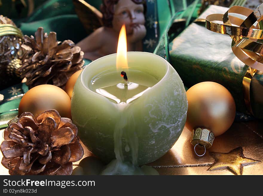 Burning candle with Christmas gift