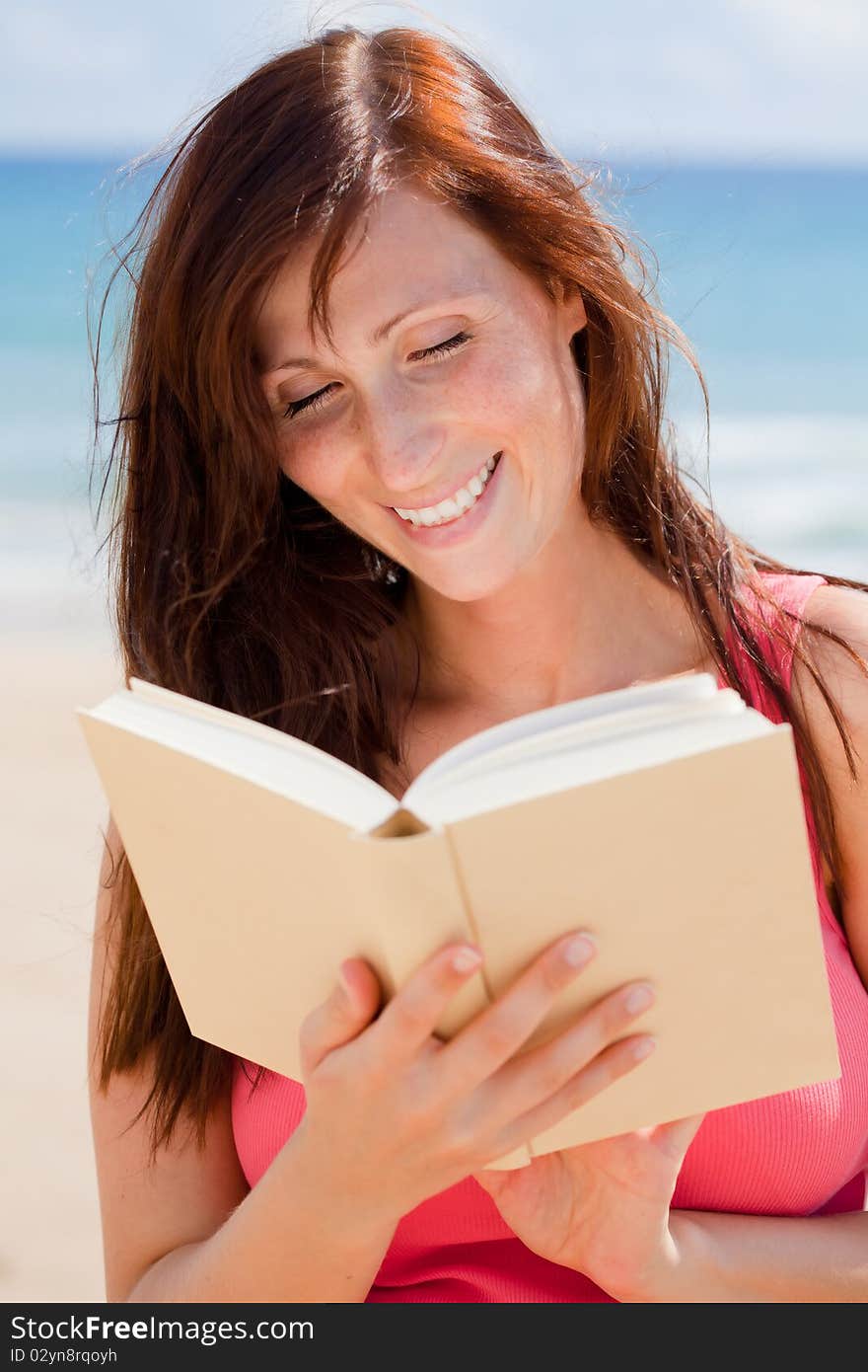 Summer traveltime woman with book with blue sky and sea behind. Summer traveltime woman with book with blue sky and sea behind