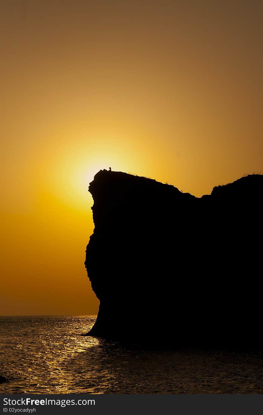 Silhouette of a man on the mountain at sunset