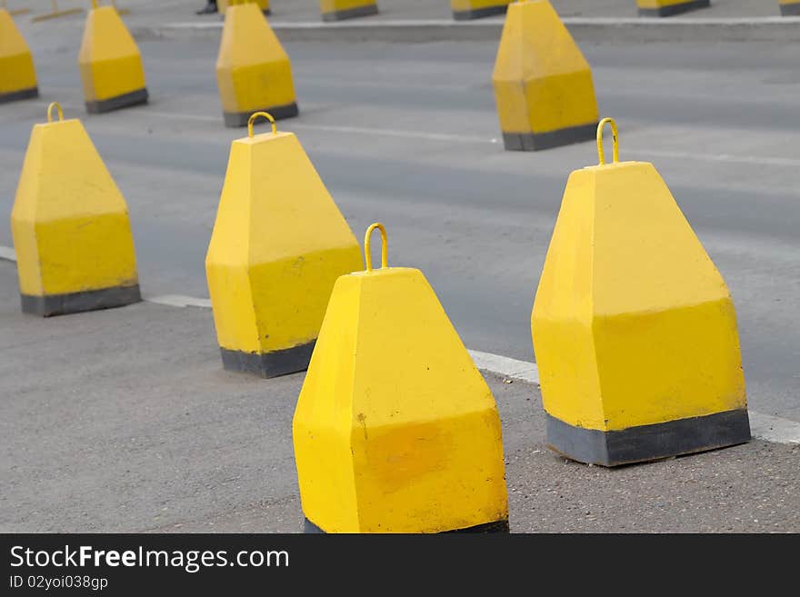 Yellow blocks from concrete partitioning off road. Yellow blocks from concrete partitioning off road