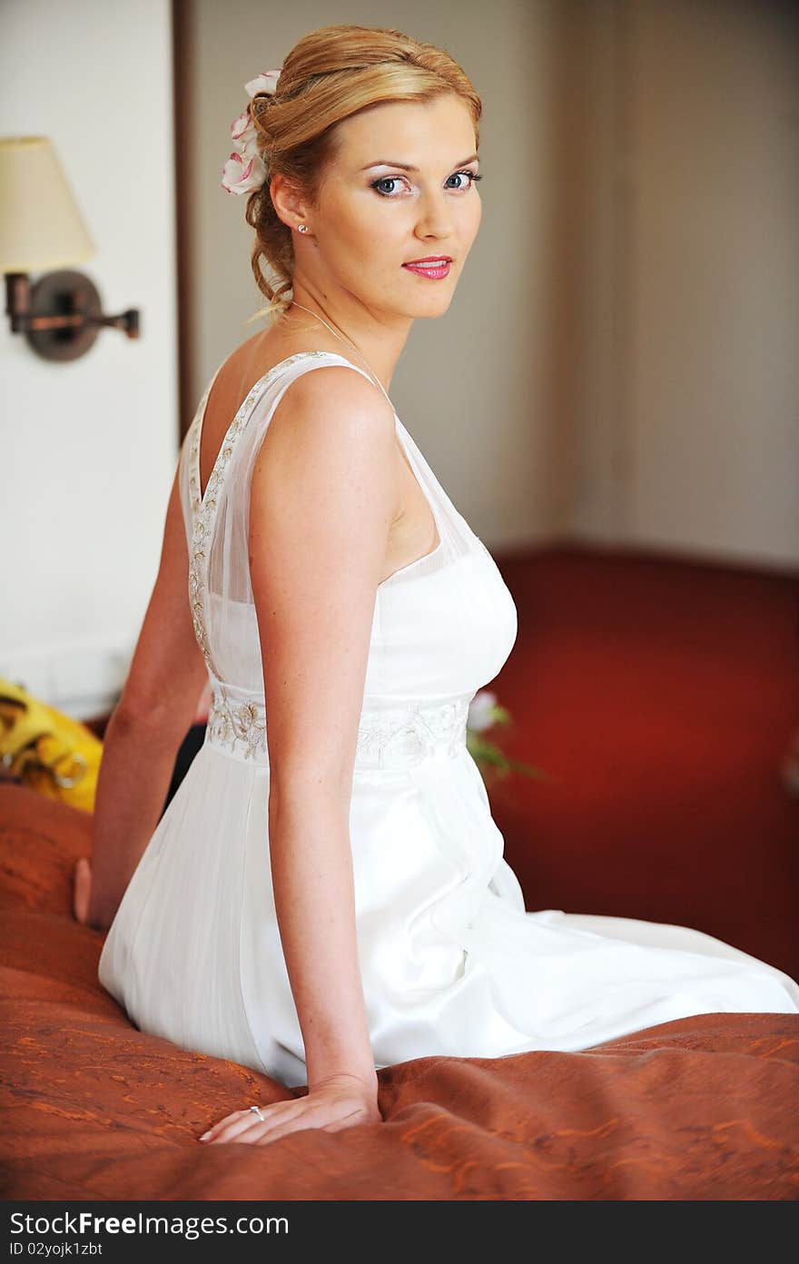 Beautiful stylish bride in white dress in room. Beautiful stylish bride in white dress in room