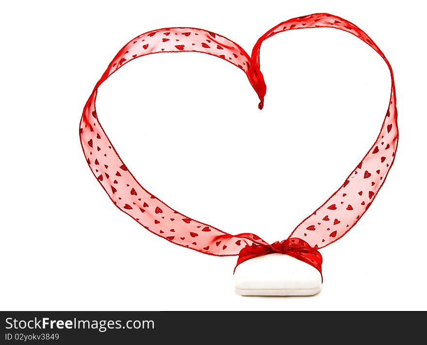 A white jeweler's box with a big red ribbon with little hearts on it and shaped into a heart. Shot on white background. A white jeweler's box with a big red ribbon with little hearts on it and shaped into a heart. Shot on white background.