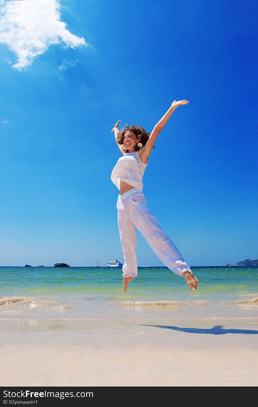 Young woman plays at the sea