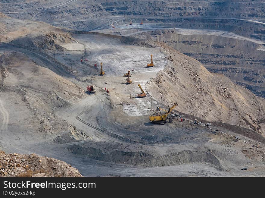 Powerful machinery working at the open stone quarry