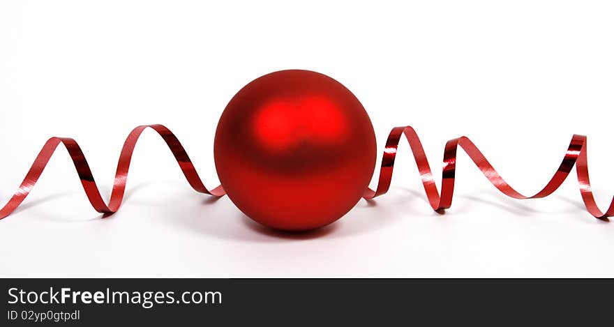 Red bauble with the red ribbon on the white background. Red bauble with the red ribbon on the white background