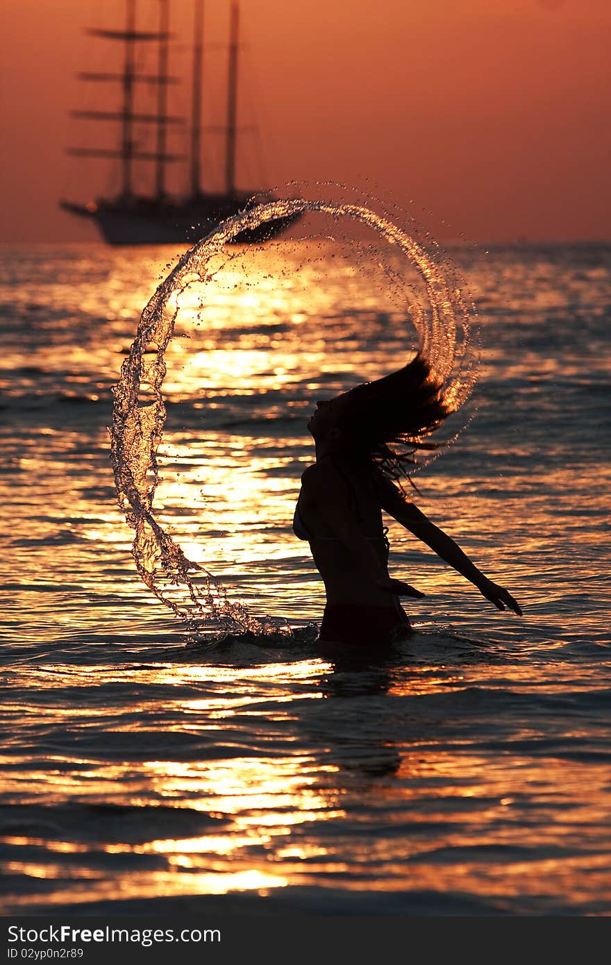 Young woman plays in water