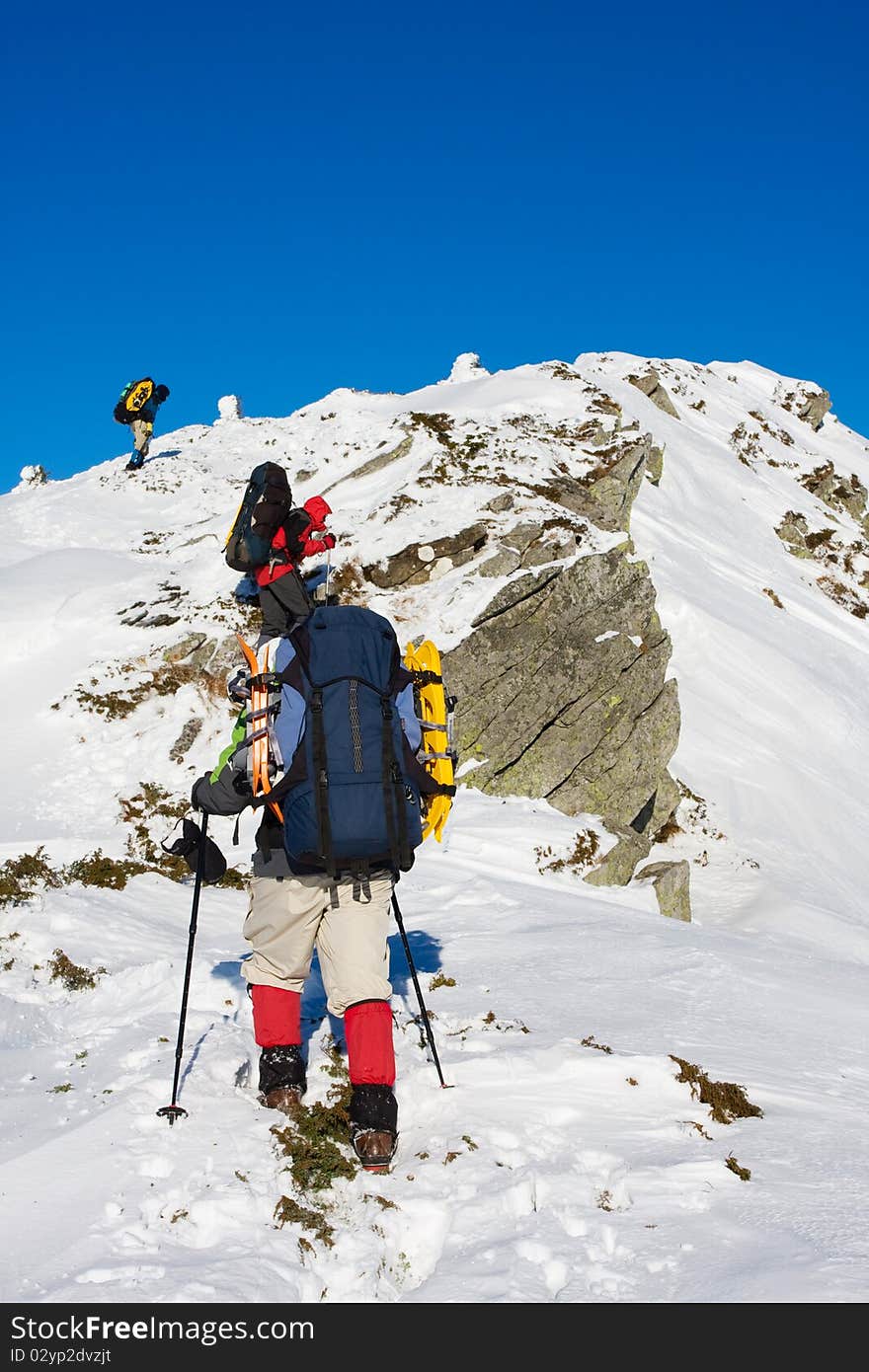 Hiker in winter in mountains