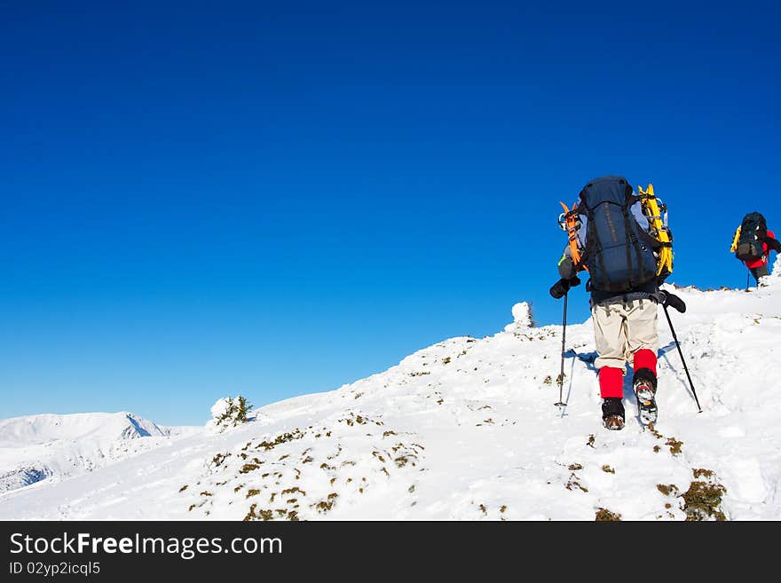 Hiker in winter in mountains