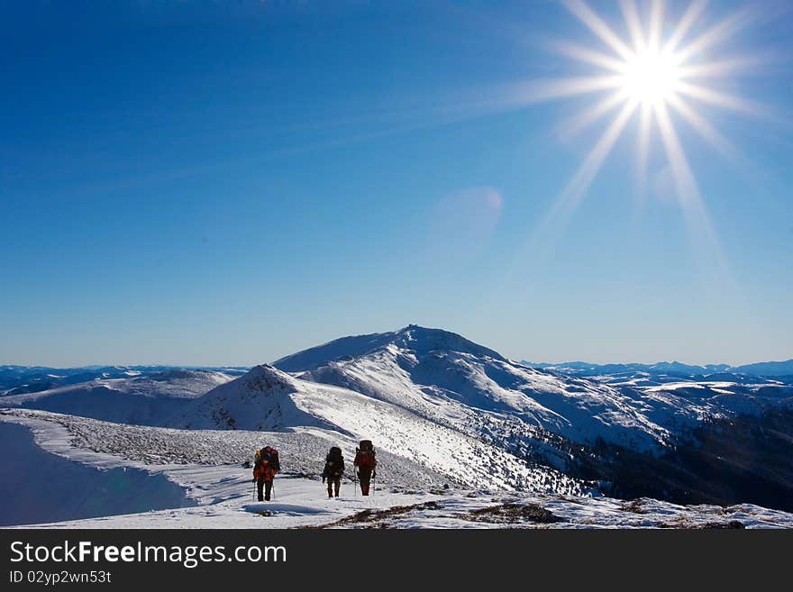 Hiker in winter in mountains