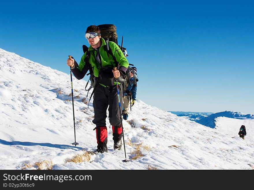 Hiker in winter in mountains