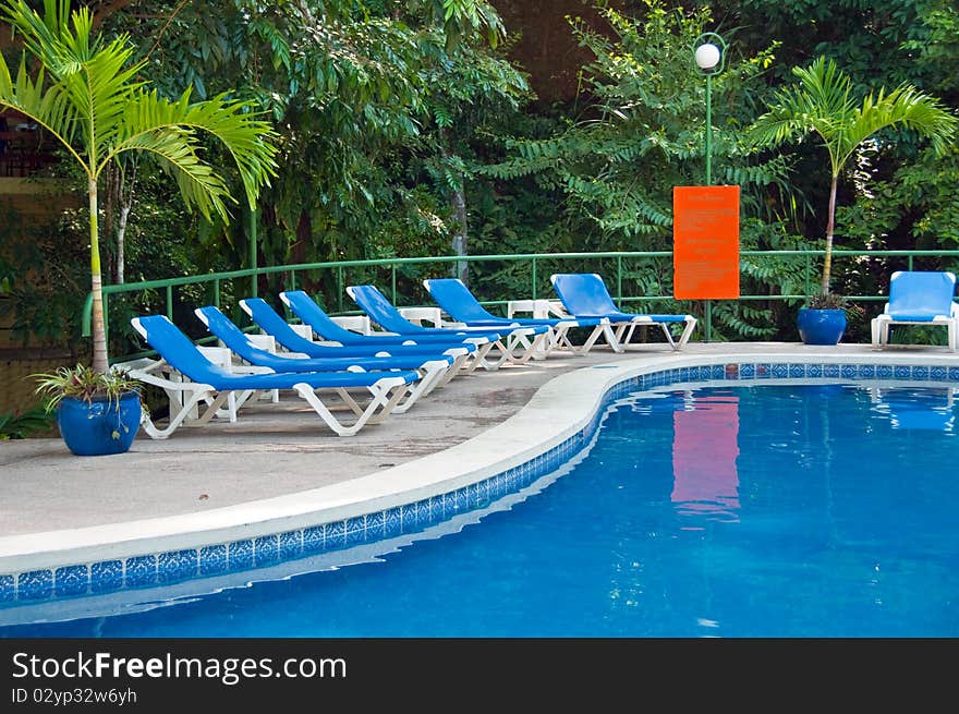 Cool, inviting swimming pool deep in tropical jungle. Cool, inviting swimming pool deep in tropical jungle.