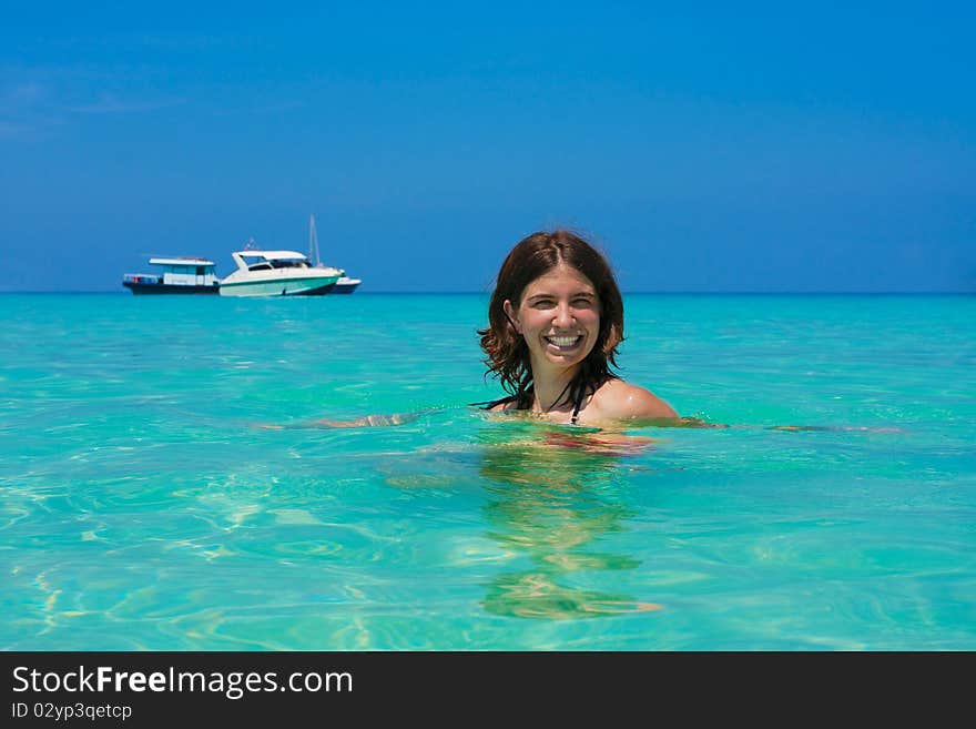 Young woman plays in water