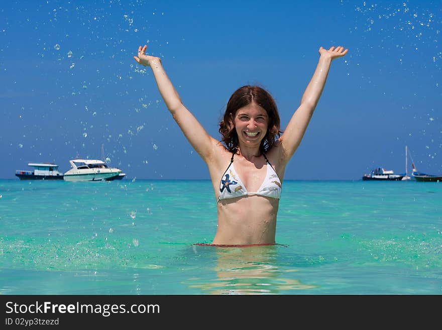 Young woman plays in water