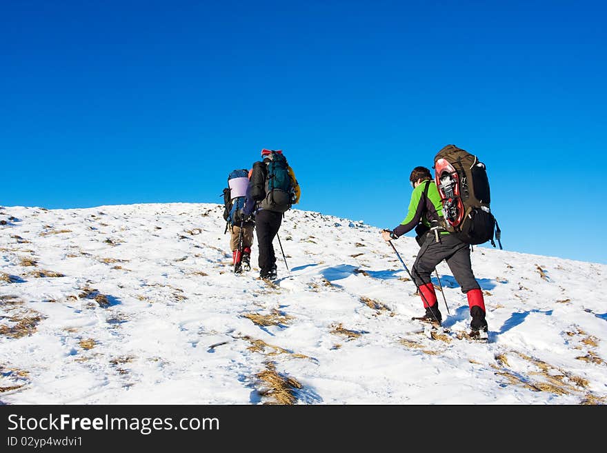 Hiker in winter in mountains